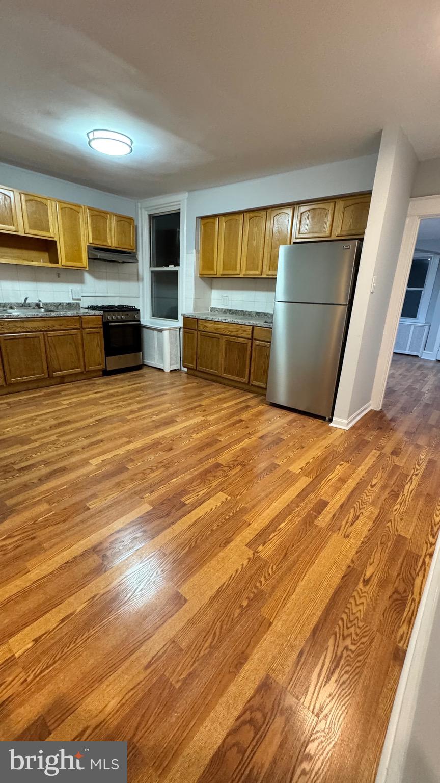 3541 Vista Street, Unit 2 Philadelphia, PA 19136 - Photo 2 of 16 a view of empty room with wooden floor and fireplace