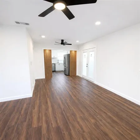 a view of a hallway with wooden floor
