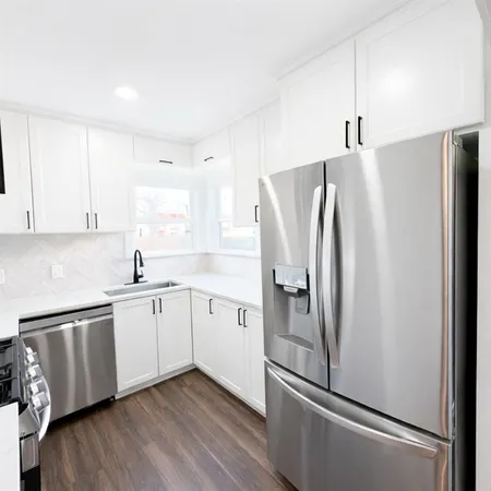 a kitchen with stainless steel appliances a refrigerator sink and cabinets