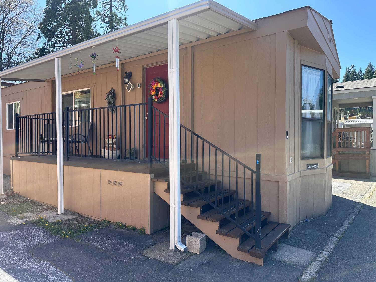 a view of a porch with wooden floor and a yard
