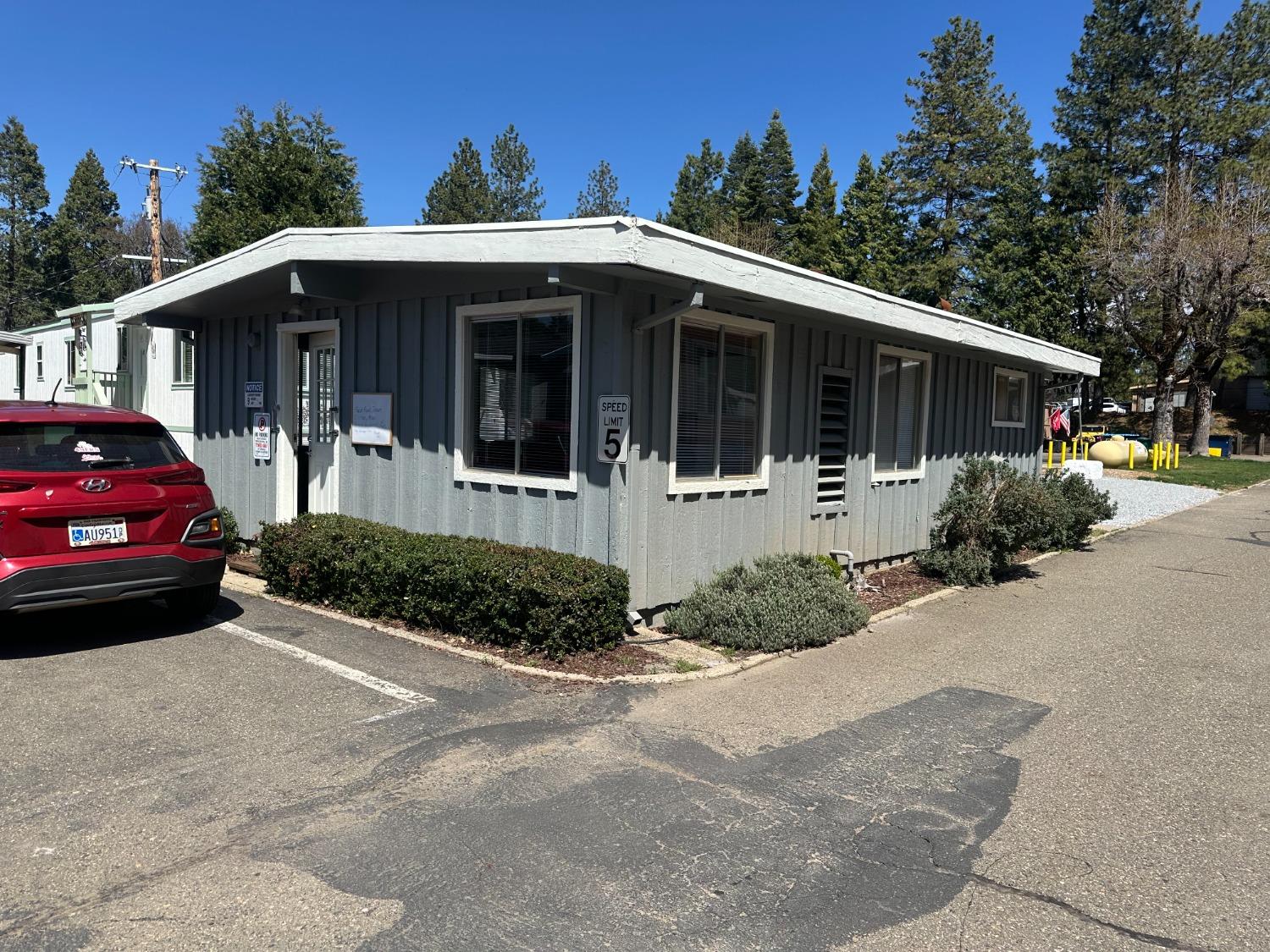 2933 Forebay Road, Unit 10 Pollock Pines, CA 95726 - Photo 28 of 28 a front view of a house with a yard and potted plants