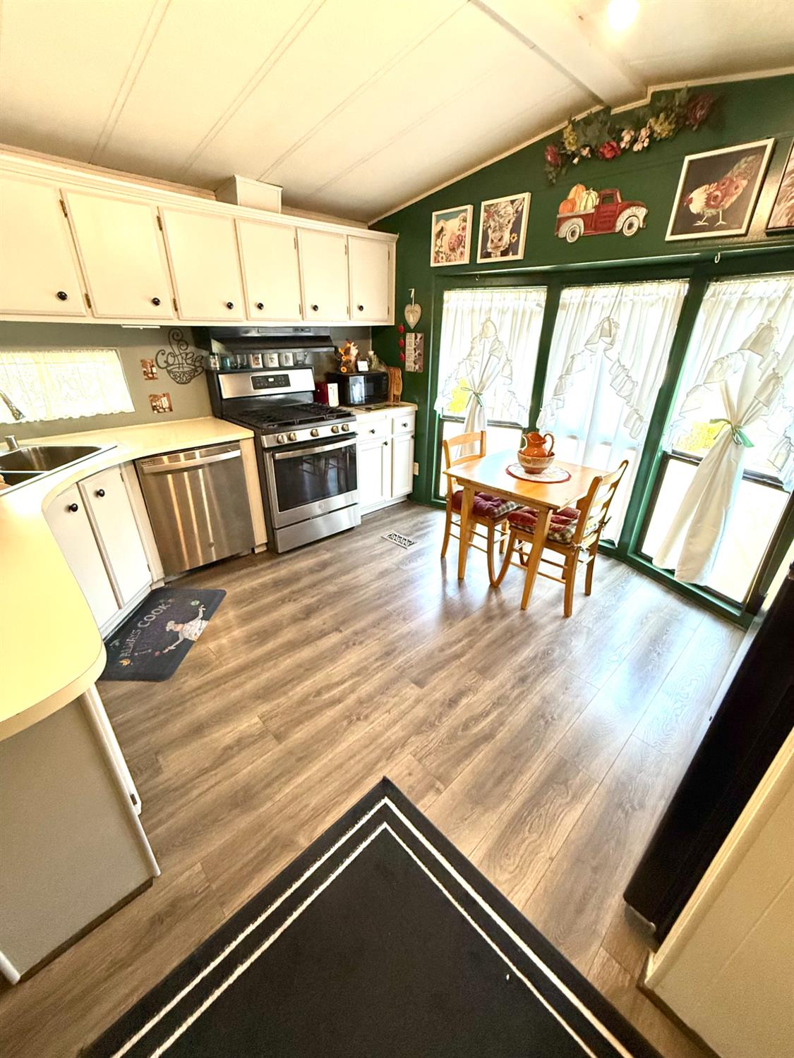 2933 Forebay Road, Unit 10 Pollock Pines, CA 95726 - Photo 3 of 28 a kitchen with stainless steel appliances kitchen island granite countertop a stove top oven and a sink with granite countertops