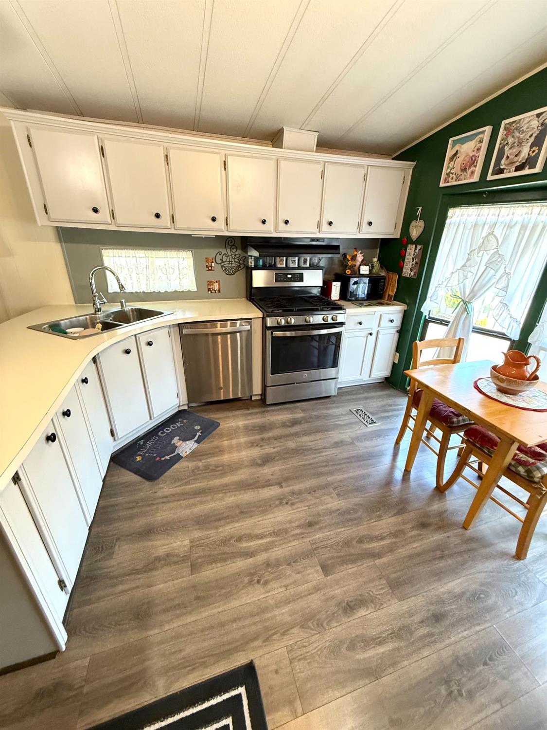 2933 Forebay Road, Unit 10 Pollock Pines, CA 95726 - Photo 4 of 28 a kitchen with stainless steel appliances white cabinets and wooden floor