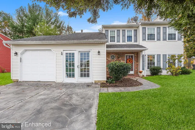 a front view of a house with a garden and plants
