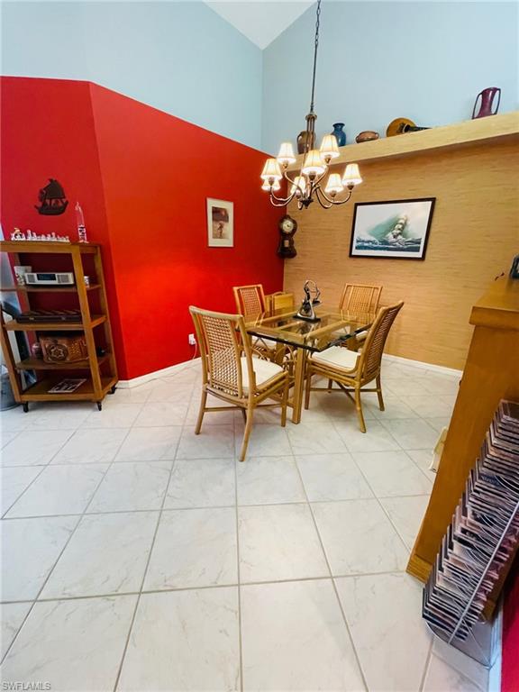 224 Napa Ridge Road East, Unit 12 Naples, FL 34119 - Photo 17 of 33 a dining room with furniture and wooden floor