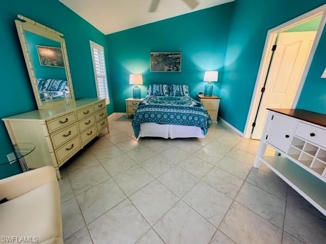 224 Napa Ridge Road East, Unit 12 Naples, FL 34119 - Photo 26 of 33 a bedroom with a bed and a mirror on dresser