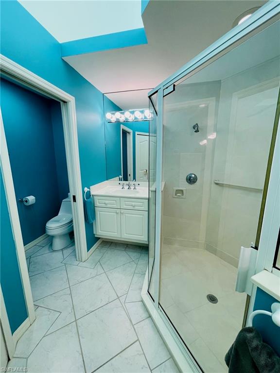 224 Napa Ridge Road East, Unit 12 Naples, FL 34119 - Photo 29 of 33 a bathroom with a sink a toilet and shower