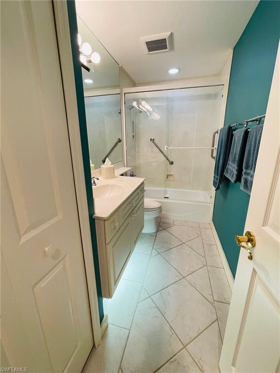 224 Napa Ridge Road East, Unit 12 Naples, FL 34119 - Photo 31 of 33 a bathroom with a sink a toilet and a shower