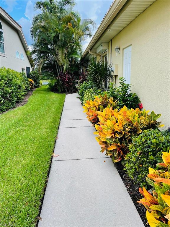 224 Napa Ridge Road East, Unit 12 Naples, FL 34119 - Photo 4 of 33 a view of a backyard with plants