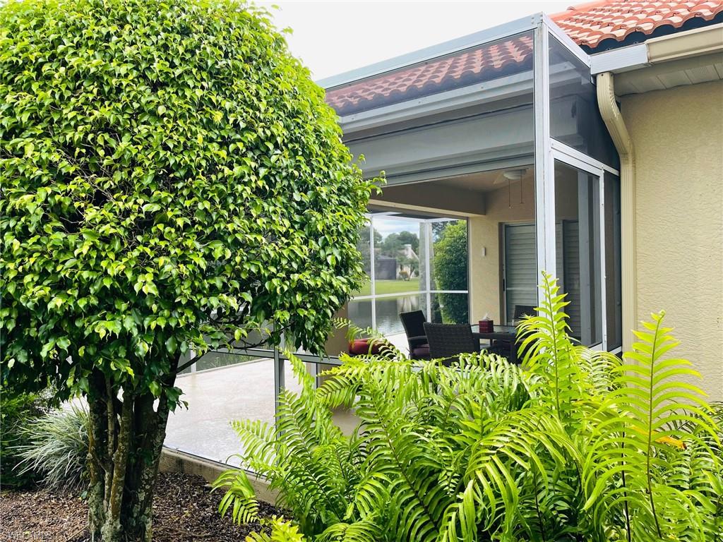 224 Napa Ridge Road East, Unit 12 Naples, FL 34119 - Photo 5 of 33 a view of a house with potted plants