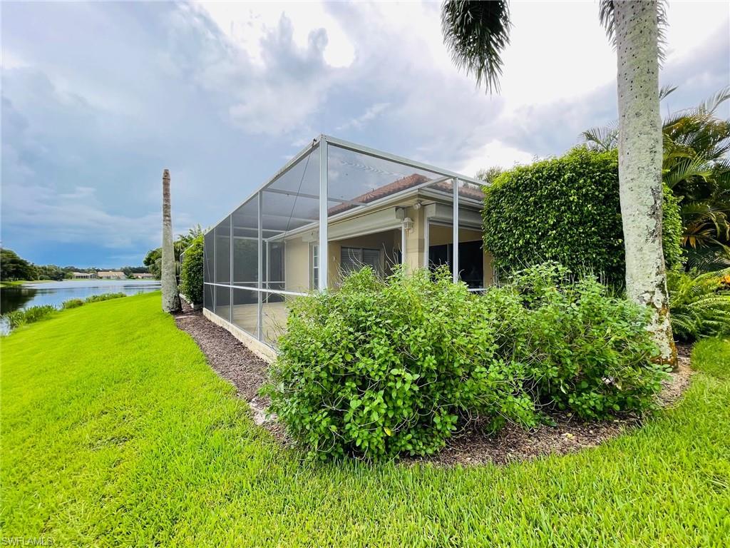 224 Napa Ridge Road East, Unit 12 Naples, FL 34119 - Photo 8 of 33 front view of a house with a yard