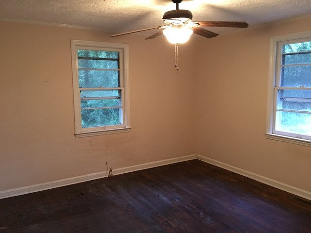 6395 Skipper Road Macon, GA 31216 - Photo 3 of 10 wooden floor in an empty room with a window