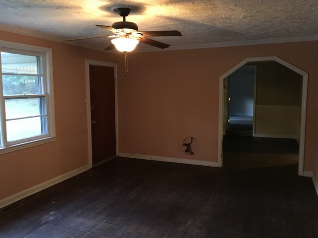 6395 Skipper Road Macon, GA 31216 - Photo 4 of 10 a view of wooden floor and a chandelier fan in a room
