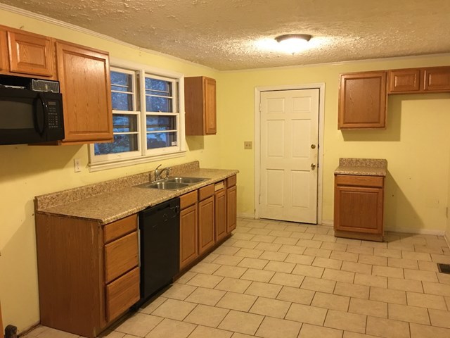 6395 Skipper Road Macon, GA 31216 - Photo 8 of 10 a kitchen with stainless steel appliances granite countertop a stove and a refrigerator