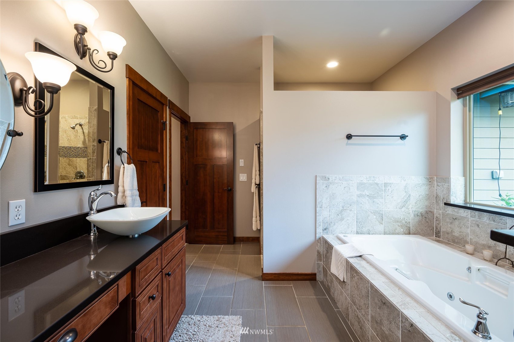 1060 Carpenter Road Bellingham, WA 98226 - Photo 15 of 37 a bathroom with a tub sink and mirror