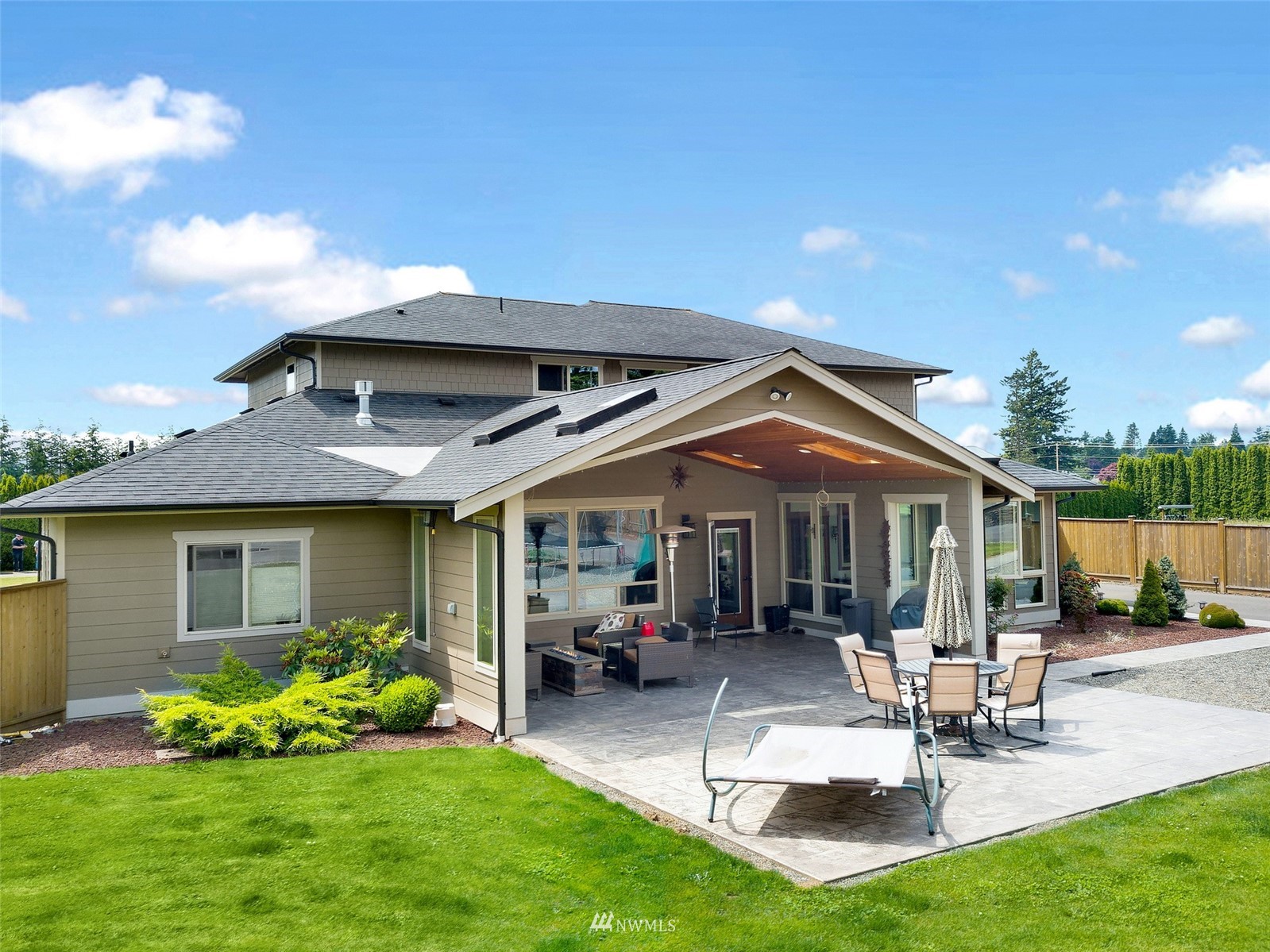 1060 Carpenter Road Bellingham, WA 98226 - Photo 26 of 37 a view of a patio with table and chairs potted plants and a large tree
