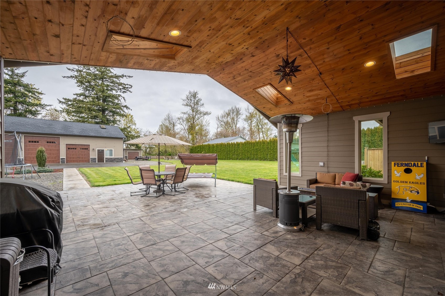 1060 Carpenter Road Bellingham, WA 98226 - Photo 28 of 37 a view of a patio with a table and chairs under an umbrella