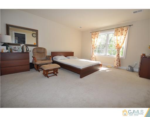 31 Parkerson Road Edison, NJ 08817 - Photo 5 of 6 a bedroom with furniture and a large window