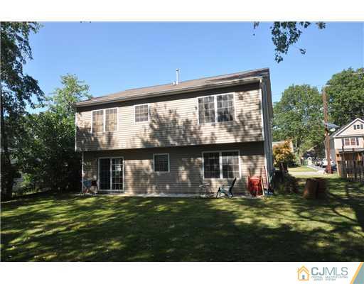 31 Parkerson Road Edison, NJ 08817 - Photo 6 of 6 a view of a house with a big yard potted plants and large tree