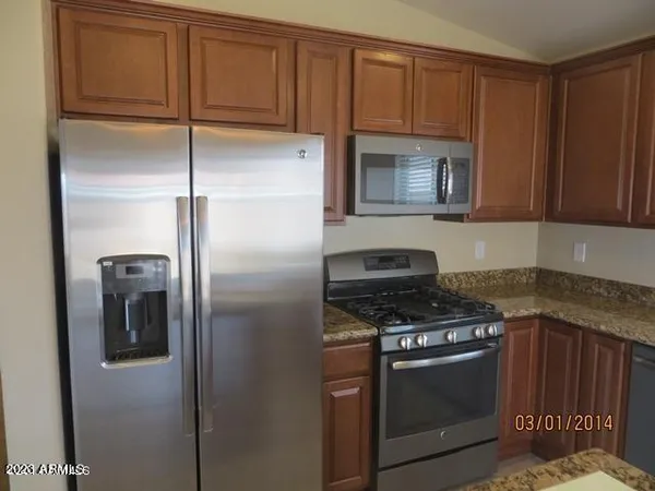 a kitchen with a stove microwave and refrigerator