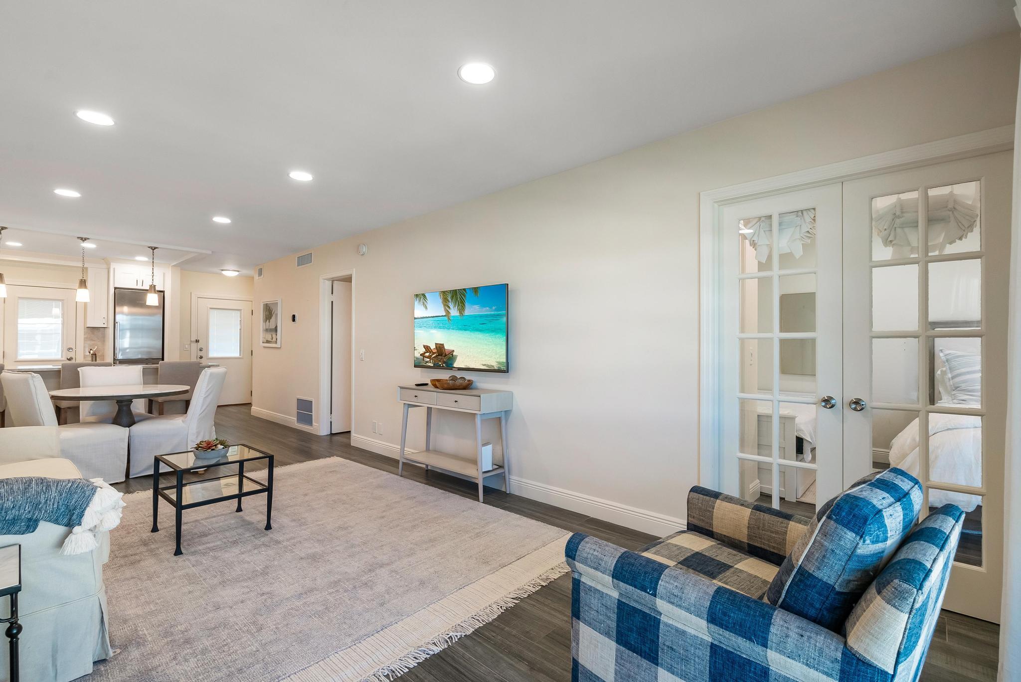 3851 North Ocean Boulevard, Unit 4100 Gulf Stream, FL 33483 - Photo 11 of 27 a living room with furniture and a flat screen tv