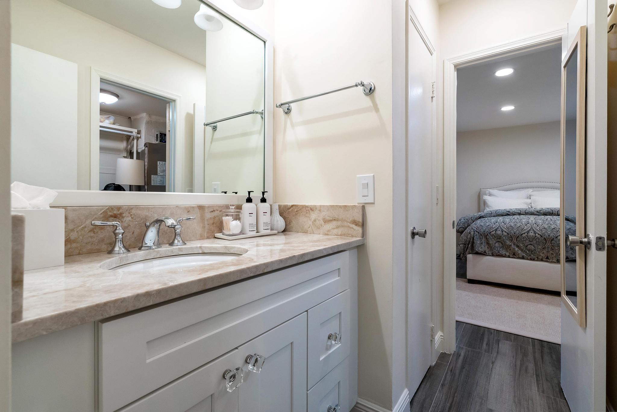 3851 North Ocean Boulevard, Unit 4100 Gulf Stream, FL 33483 - Photo 16 of 27 a en suite bathroom with a granite countertop sink and a mirror