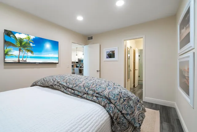 a bedroom with a bed and a painting on the wall