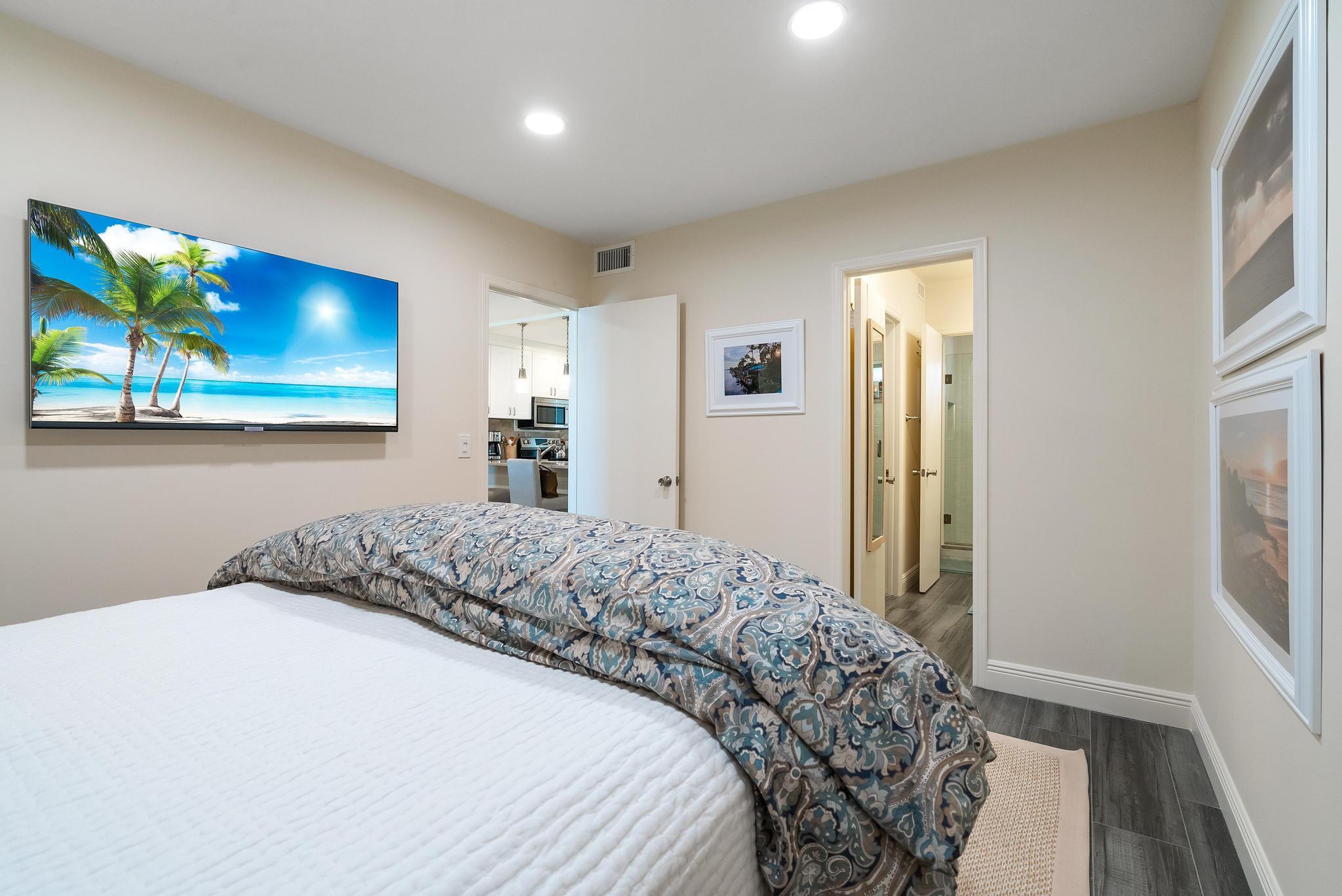 3851 North Ocean Boulevard, Unit 4100 Gulf Stream, FL 33483 - Photo 18 of 27 a bedroom with a bed and a painting on the wall