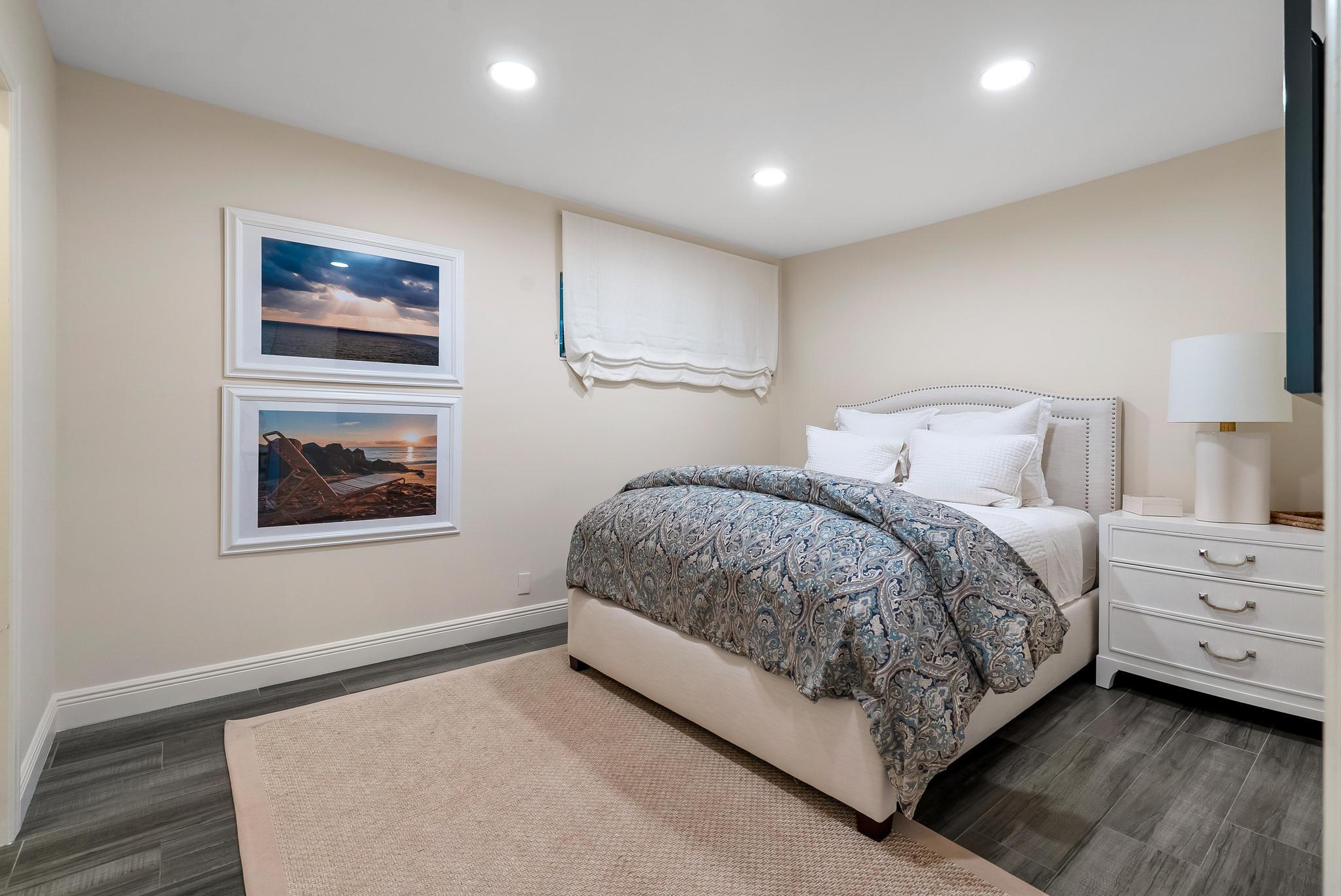 3851 North Ocean Boulevard, Unit 4100 Gulf Stream, FL 33483 - Photo 19 of 27 a bedroom with a bed and a painting on the wall