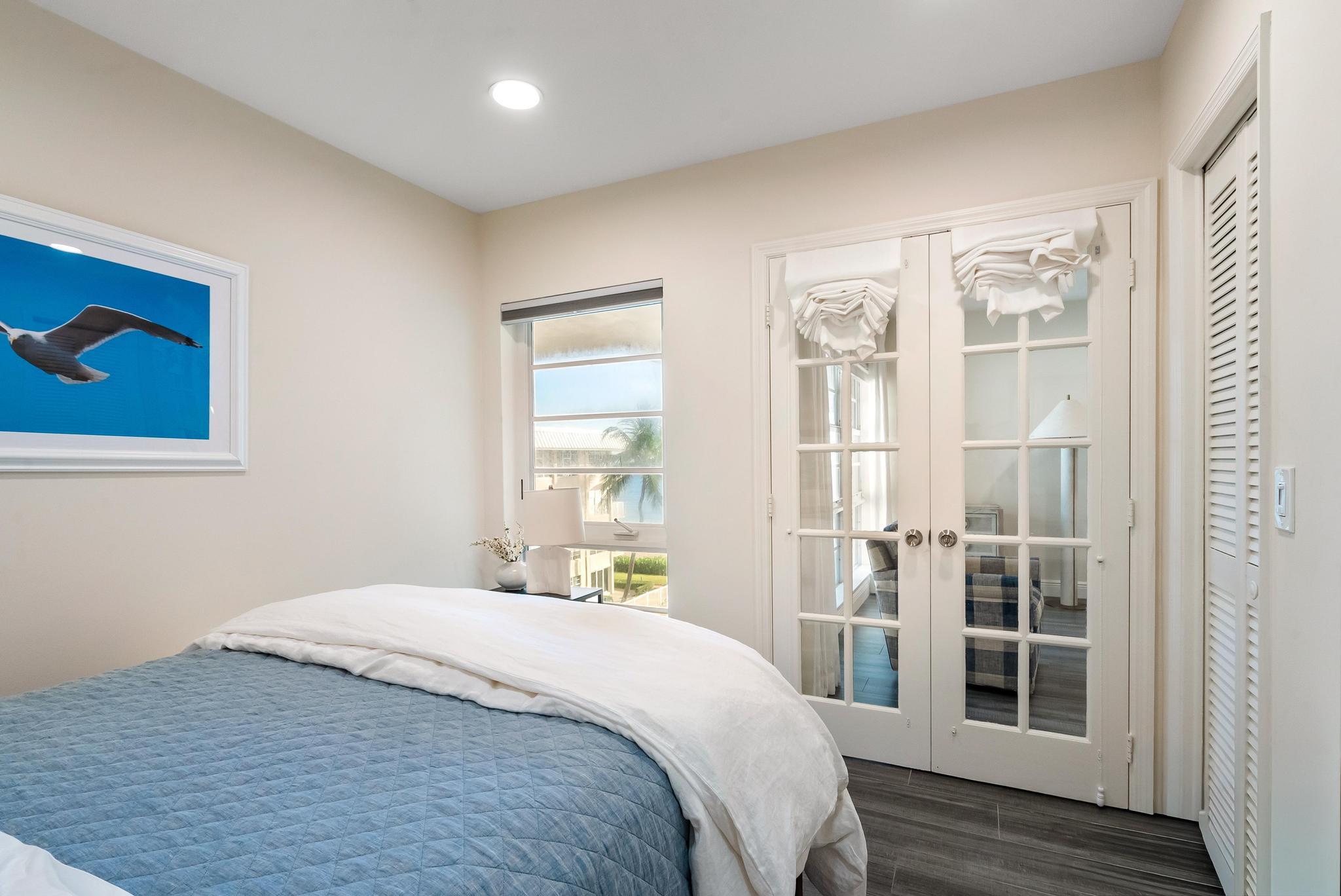 3851 North Ocean Boulevard, Unit 4100 Gulf Stream, FL 33483 - Photo 21 of 27 a bedroom with a large bed and a window