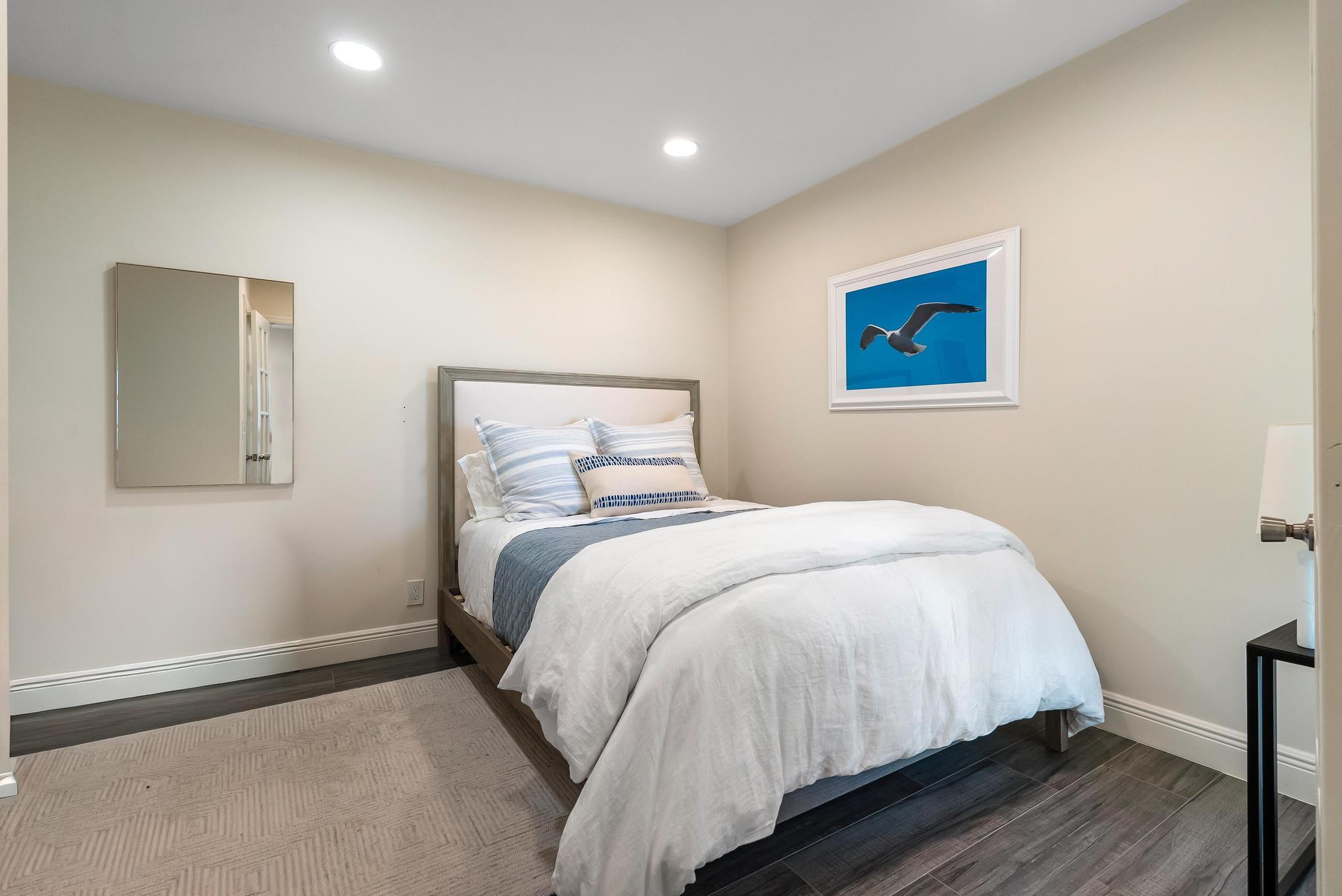 3851 North Ocean Boulevard, Unit 4100 Gulf Stream, FL 33483 - Photo 22 of 27 a bedroom with a bed and wooden floor