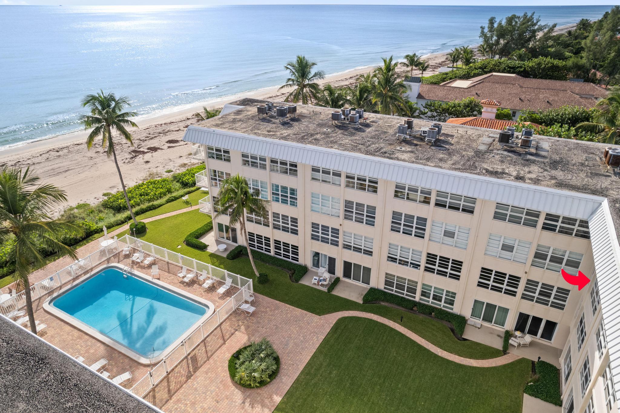 3851 North Ocean Boulevard, Unit 4100 Gulf Stream, FL 33483 - Photo 24 of 27 a view of a swimming pool with outdoor seating and plants