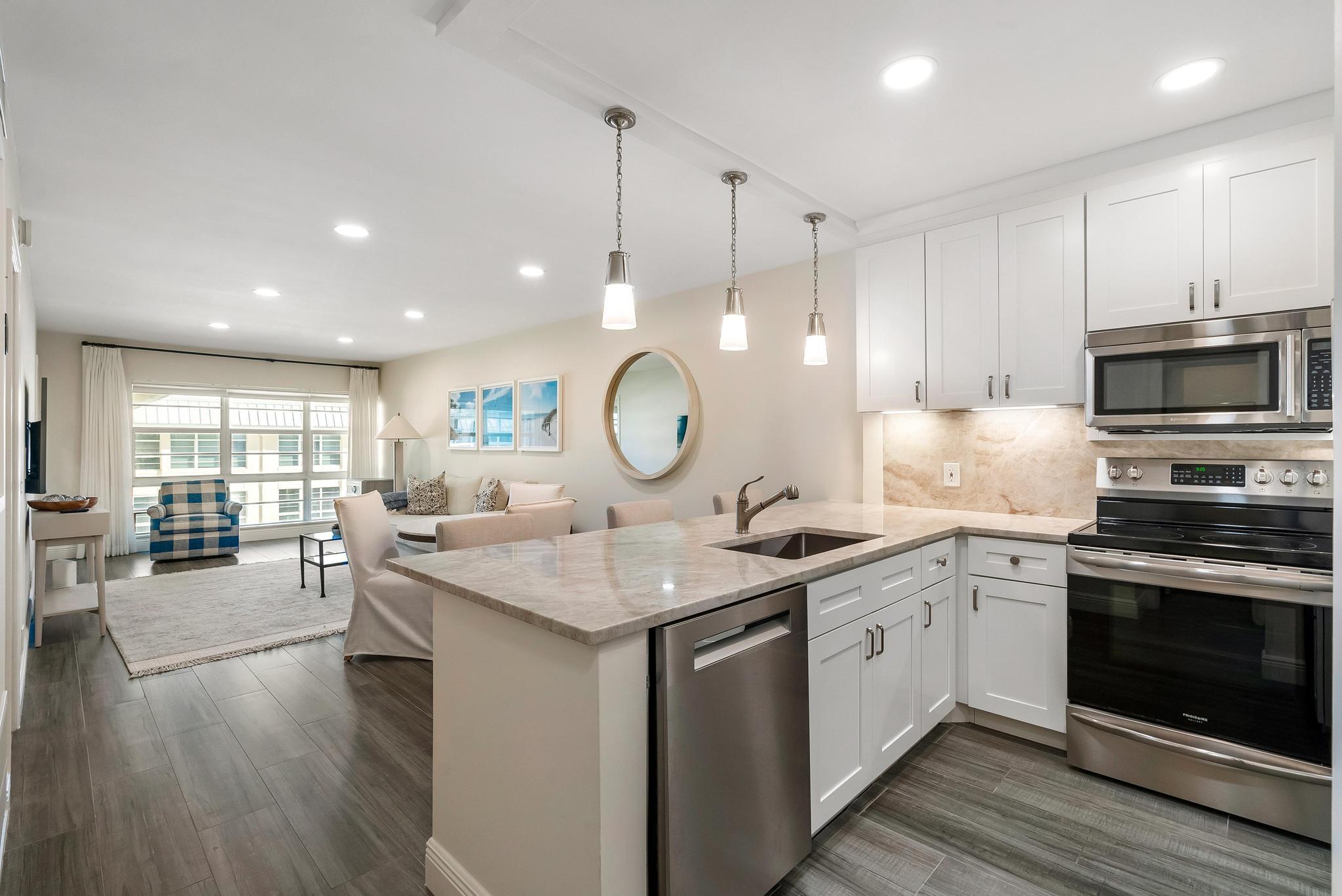 3851 North Ocean Boulevard, Unit 4100 Gulf Stream, FL 33483 - Photo 3 of 27 a kitchen with a sink stove and cabinets