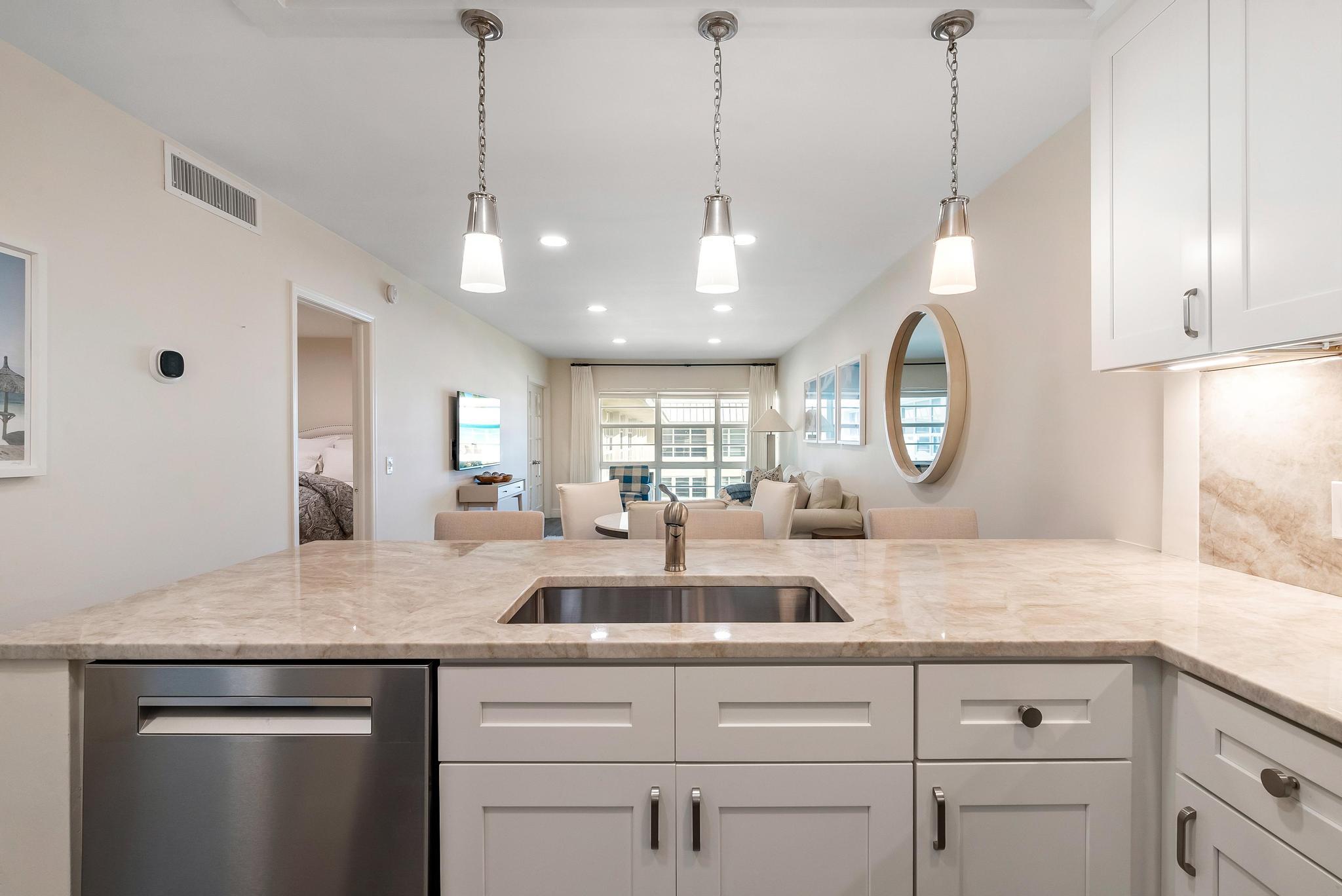 3851 North Ocean Boulevard, Unit 4100 Gulf Stream, FL 33483 - Photo 8 of 27 a view of a kitchen counter space and a sink chandelier