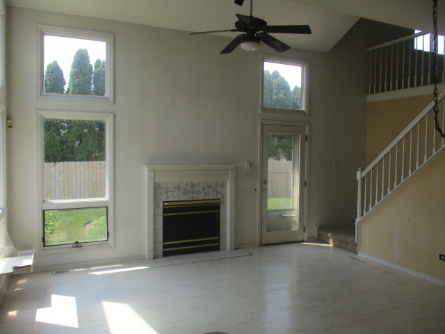1901 Calla Drive Joliet, IL 60435 - Photo 2 of 27 a view of empty room with fireplace and windows