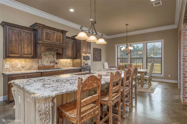 a view of a dining room with furniture wooden floor and chandelier