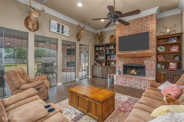 a living room with furniture a flat screen tv and a fireplace