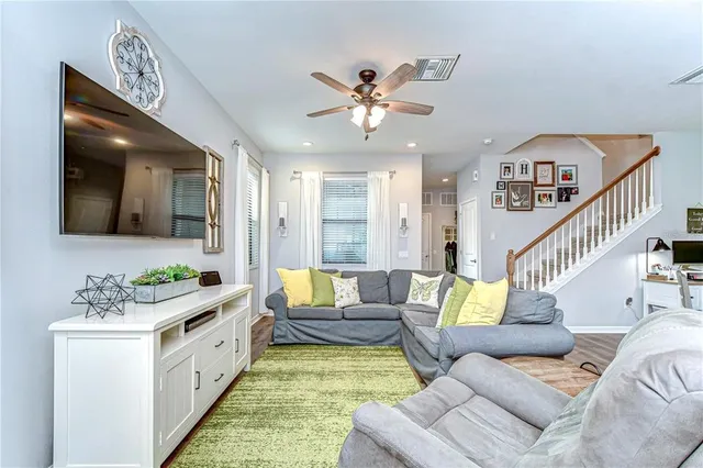 a living room with furniture rug and window