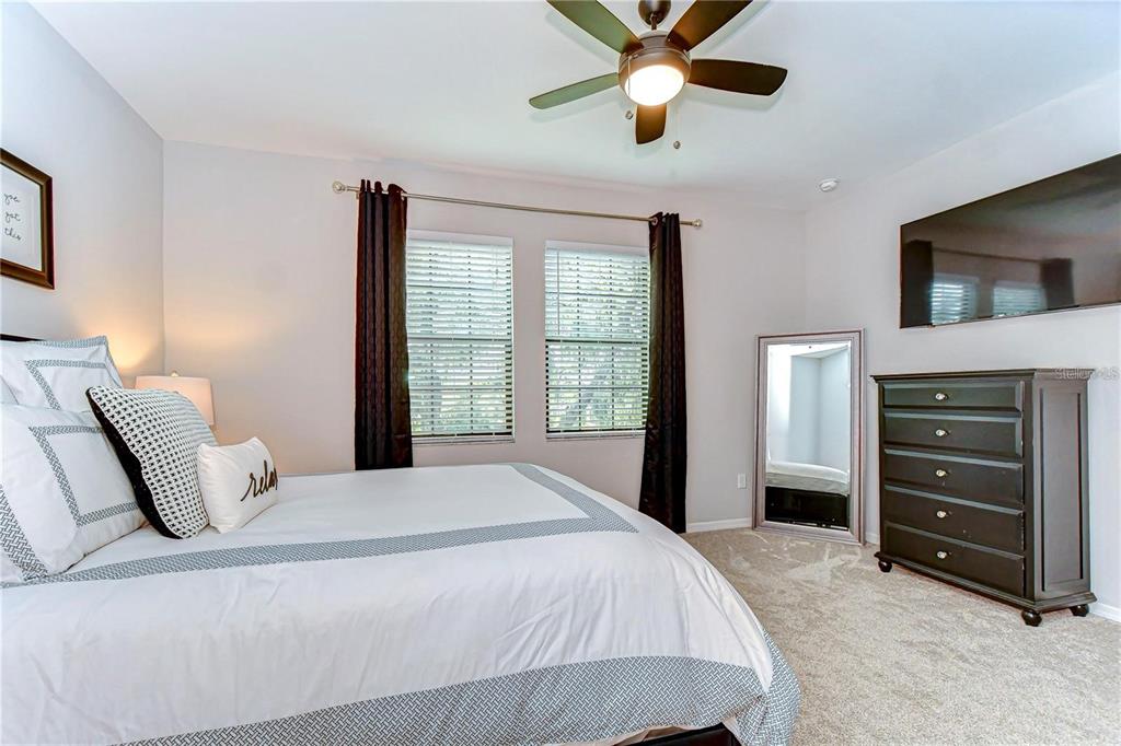 5703 Colony Glen Road Lithia, FL 33547 - Photo 29 of 53 a bedroom with a bed and a television