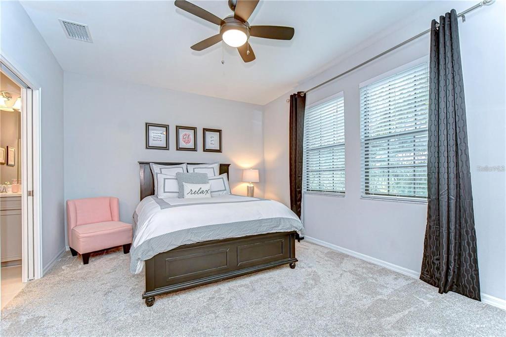 5703 Colony Glen Road Lithia, FL 33547 - Photo 31 of 53 a spacious bedroom with a bed and a chandelier