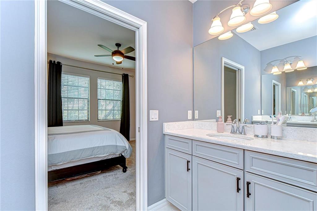 5703 Colony Glen Road Lithia, FL 33547 - Photo 33 of 53 a en suite bathroom with a double vanity sink and a mirror