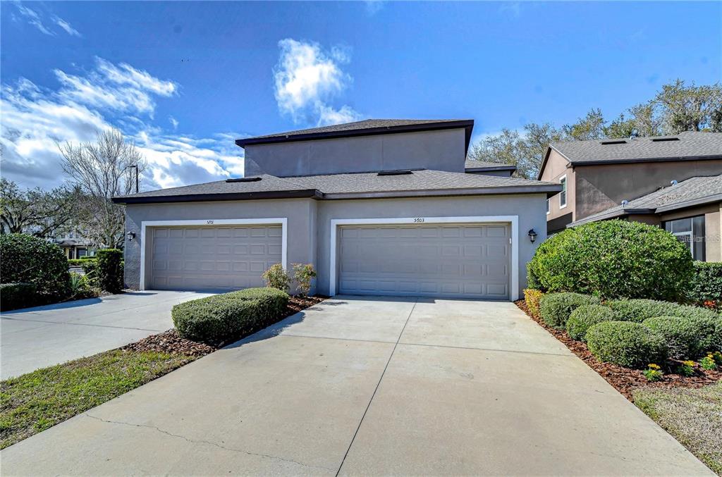 5703 Colony Glen Road Lithia, FL 33547 - Photo 38 of 53 a front view of a house with a yard and garage