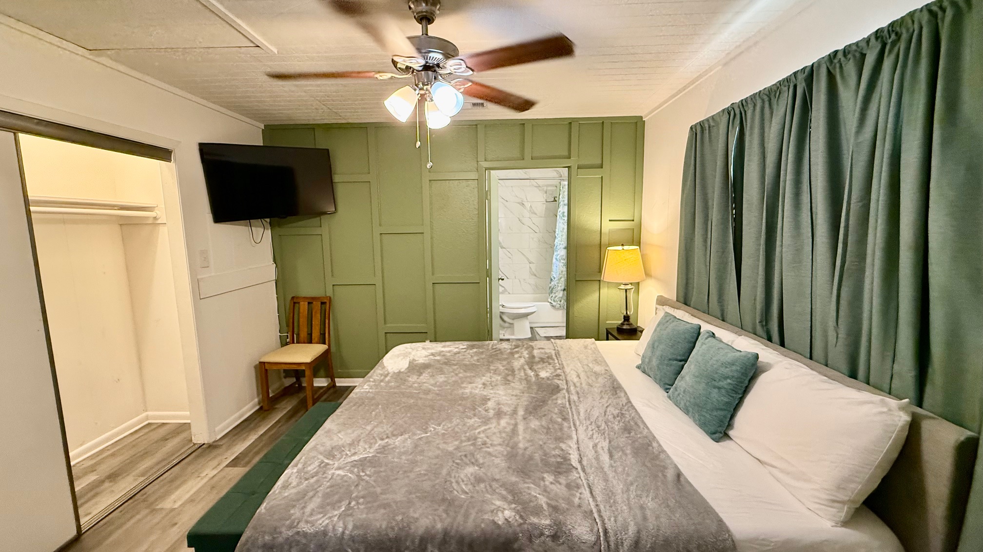 1802 East University Avenue, Unit A Georgetown, TX 78626 - Photo 5 of 23 Bedroom featuring wood finished floors, connected bathroom, ceiling fan, and ornamental molding