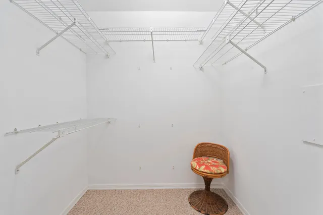 a bedroom with a bed and large windows