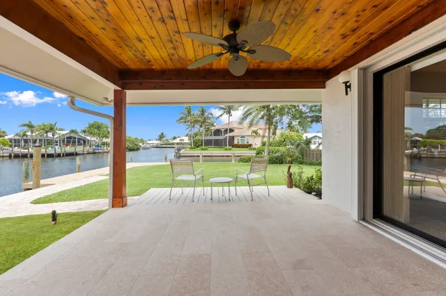 a view of a porch with chairs and backyard