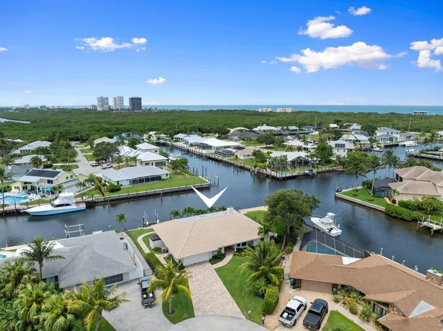 a view of a terrace with lawn chairs and a table