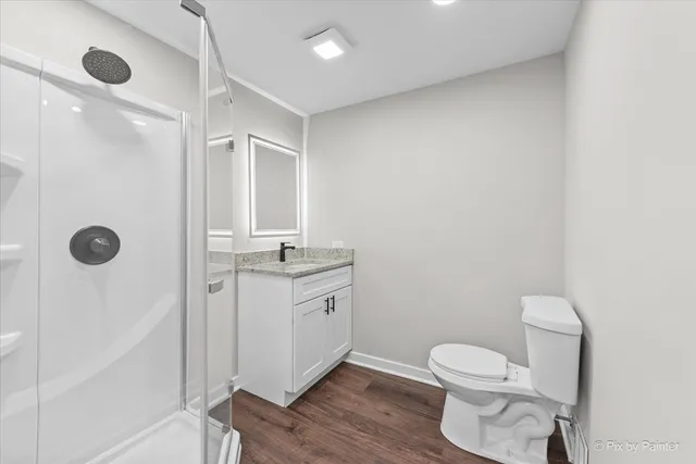 a bathroom with a granite countertop sink toilet and shower