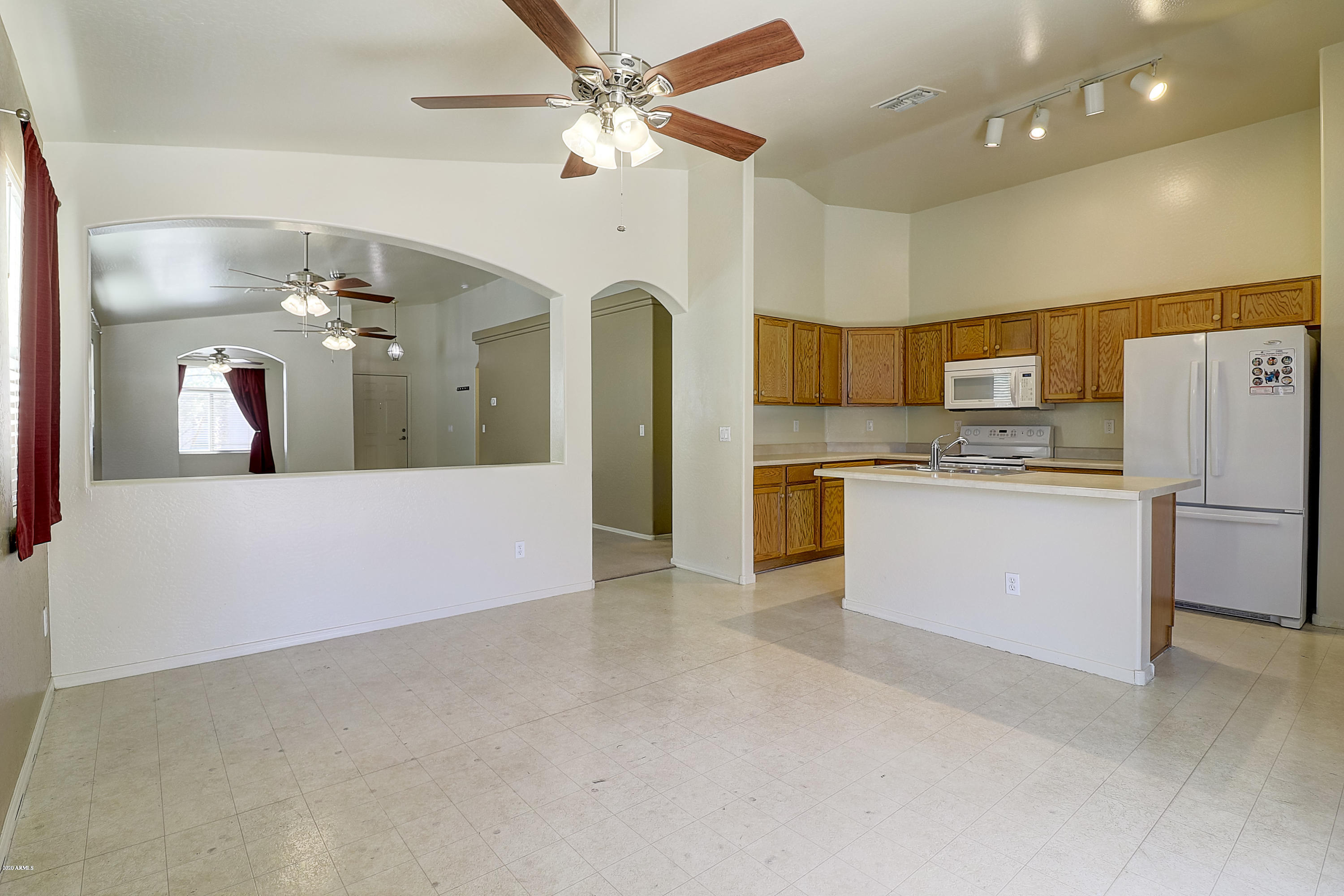 8461 West Riley Road Tolleson, AZ 85353 - Photo 11 of 25 a view of a kitchen with a sink and refrigerator