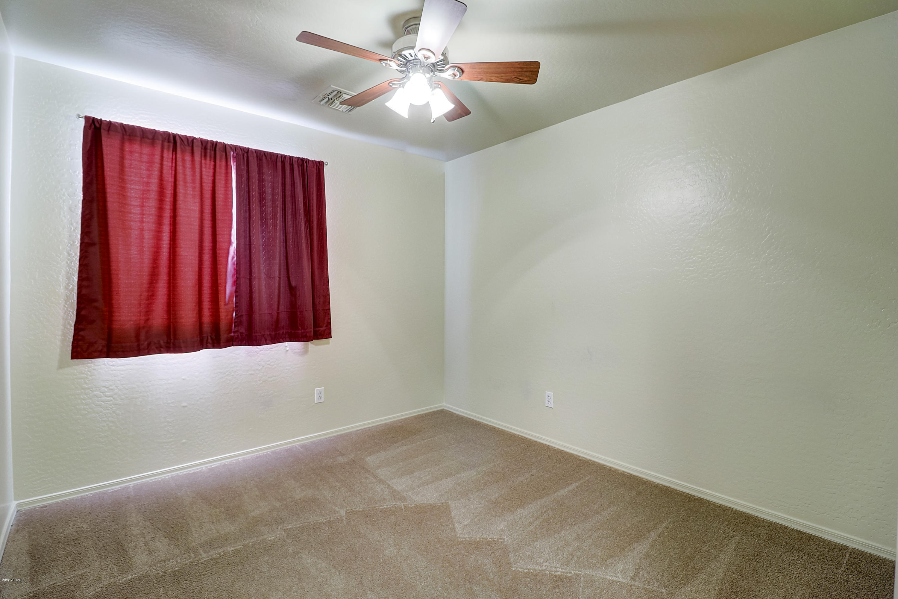 8461 West Riley Road Tolleson, AZ 85353 - Photo 17 of 25 an empty room with windows and fan