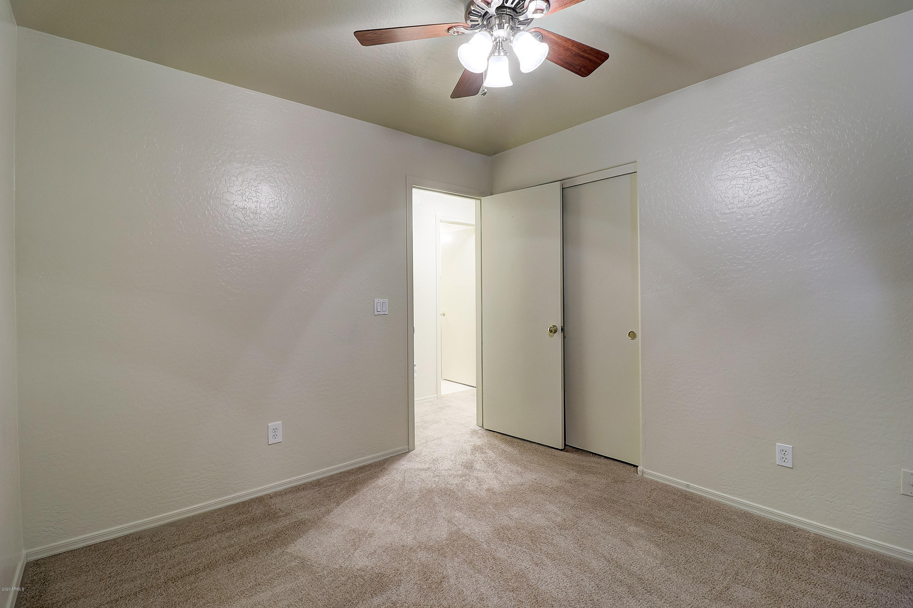 8461 West Riley Road Tolleson, AZ 85353 - Photo 18 of 25 an empty room with a chandelier fan